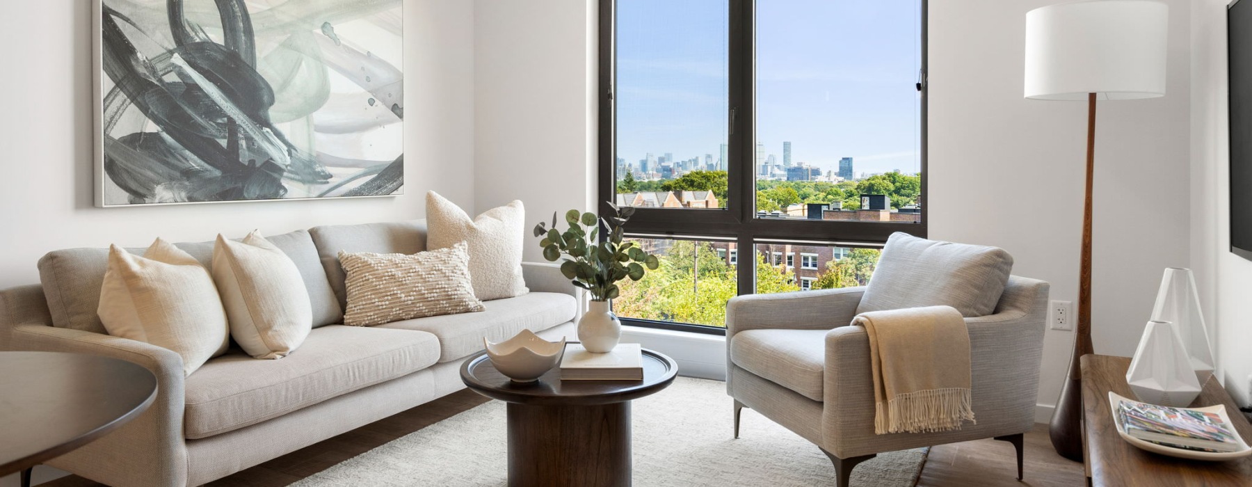 living room with a couch, chair  and large window