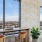 a desk and chairs with a view of the city through a window