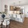 a kitchen with white chairs