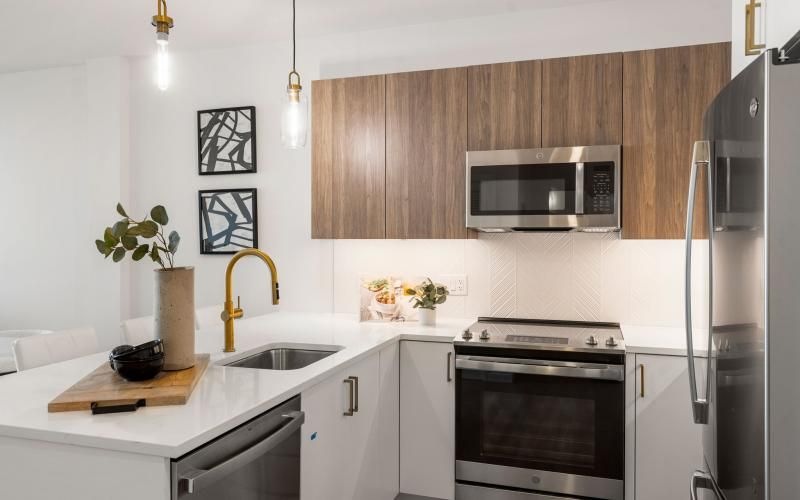 a kitchen with a stainless steel microwave oven and a stainless steel refrigerator