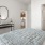 a bedroom with a bed and a mirror