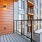 a deck with a railing and a building with a wood deck